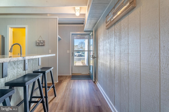 doorway featuring sink and wood-type flooring