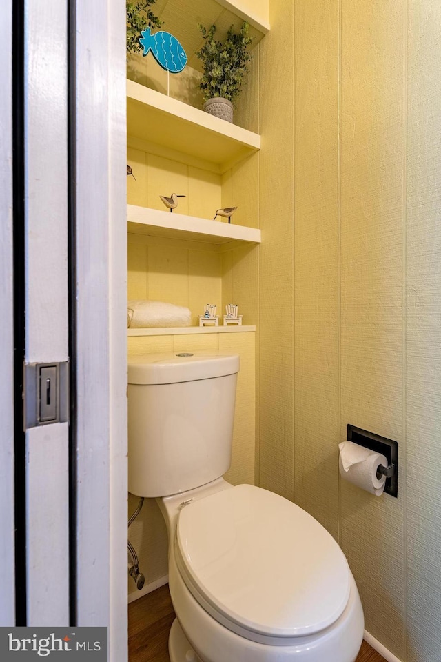 bathroom featuring hardwood / wood-style flooring and toilet