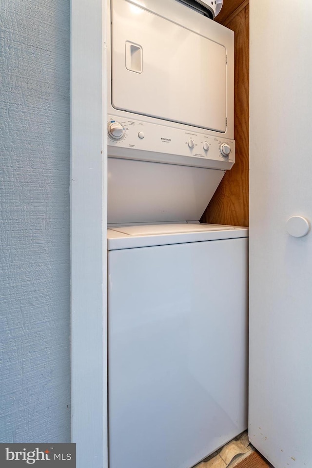 laundry room with stacked washer and dryer