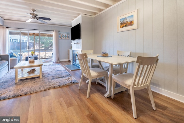 dining space featuring beam ceiling, ceiling fan, and light hardwood / wood-style floors