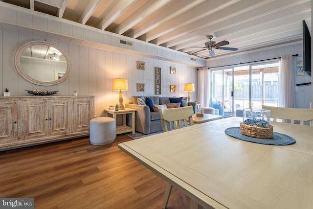 living room with ceiling fan, hardwood / wood-style flooring, and beamed ceiling