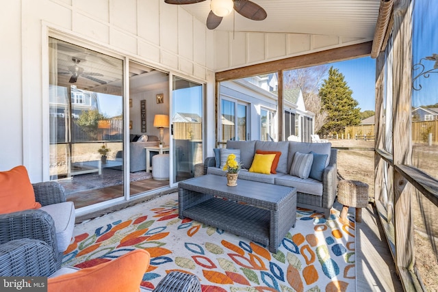 sunroom featuring ceiling fan and lofted ceiling