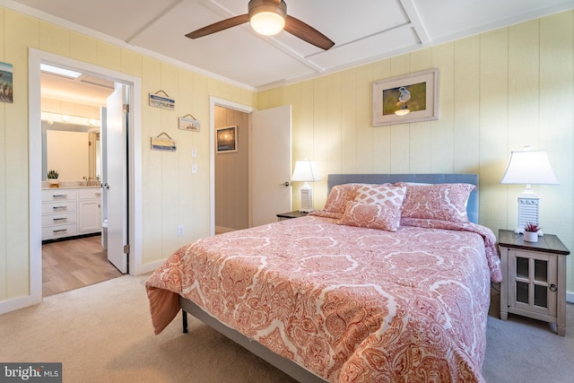 bedroom featuring crown molding, light carpet, ensuite bathroom, and ceiling fan