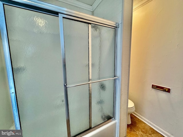 bathroom with toilet, shower / bath combination with glass door, and tile patterned flooring