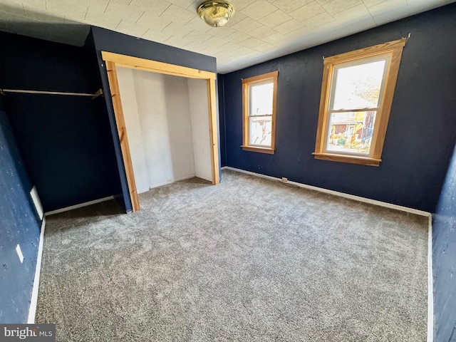 unfurnished bedroom with carpet floors and a closet