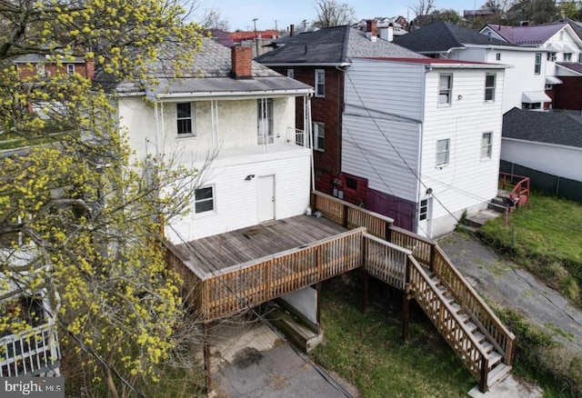 back of house featuring a deck