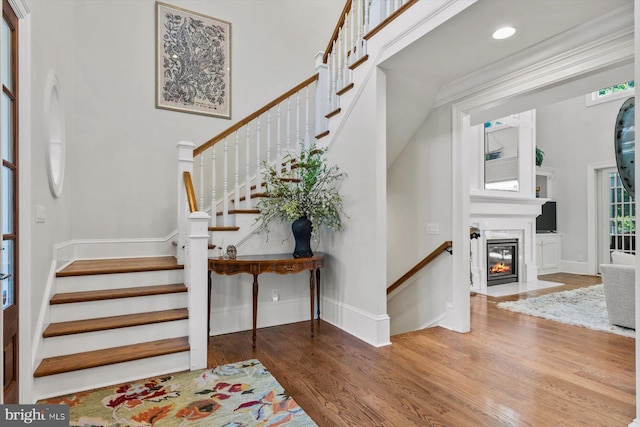 entrance foyer with a high ceiling and hardwood / wood-style floors