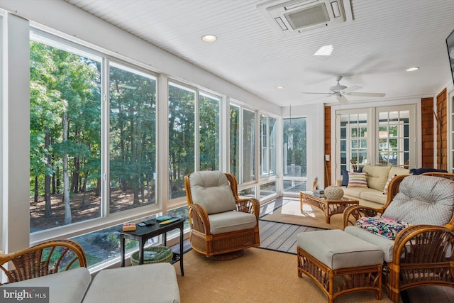 sunroom / solarium featuring ceiling fan