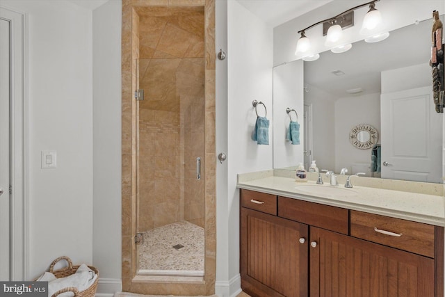 bathroom with vanity and a shower with door