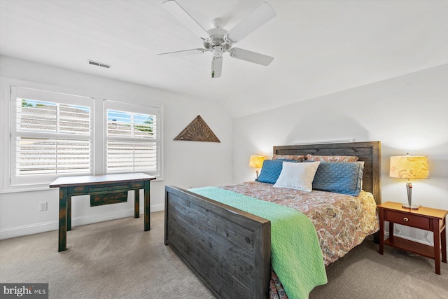 bedroom featuring light carpet, vaulted ceiling, and ceiling fan