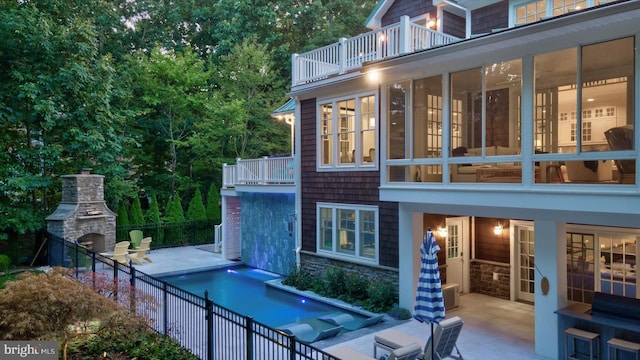 view of pool with a fireplace and a patio area