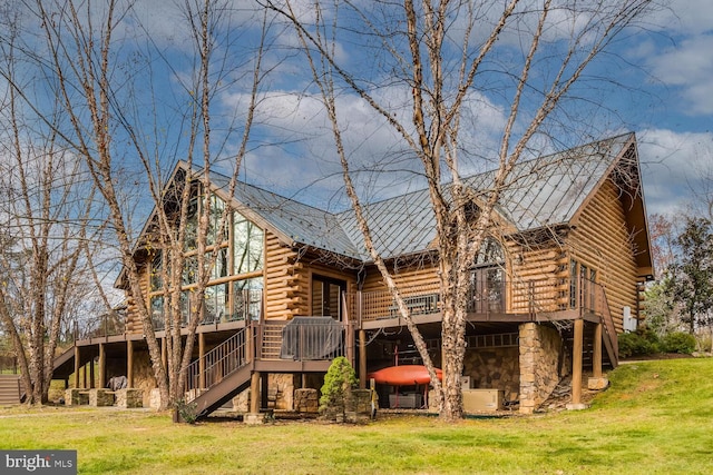 rear view of house with a yard and a deck