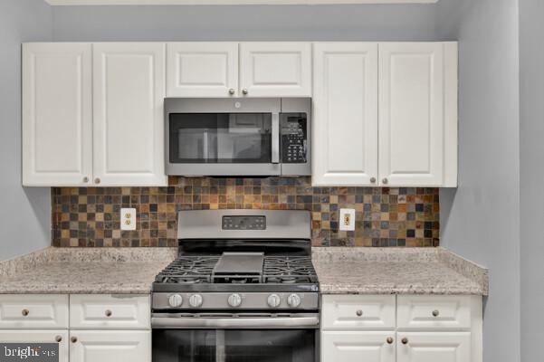 kitchen with white cabinetry and stainless steel appliances