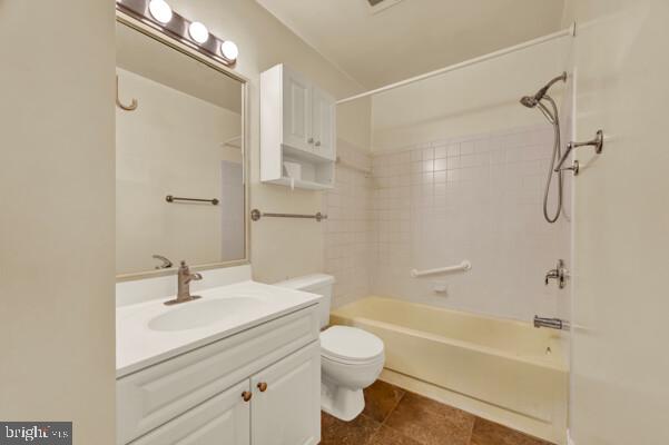 full bathroom featuring shower / washtub combination, tile patterned flooring, vanity, and toilet