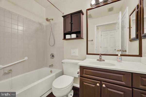 full bathroom with toilet, visible vents, shower / washtub combination, and vanity