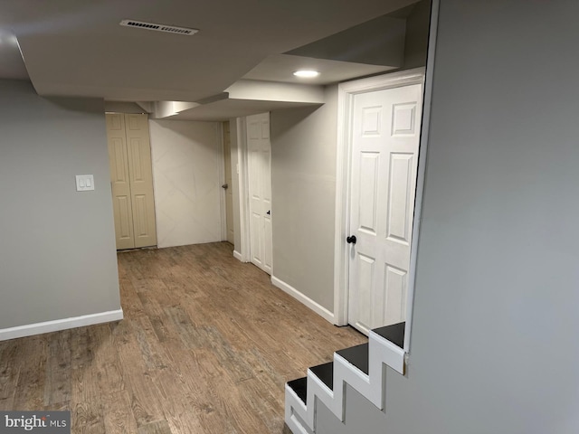 basement featuring hardwood / wood-style floors