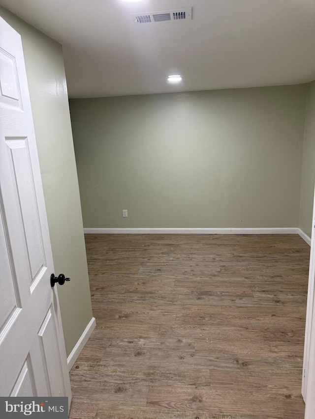 spare room featuring wood-type flooring