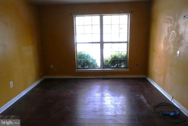 spare room featuring dark hardwood / wood-style flooring