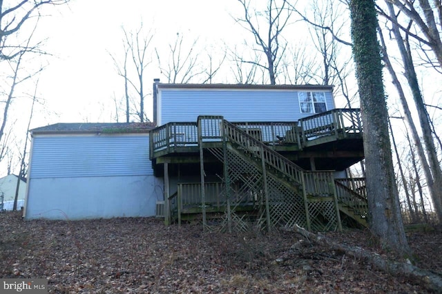 back of house featuring a wooden deck