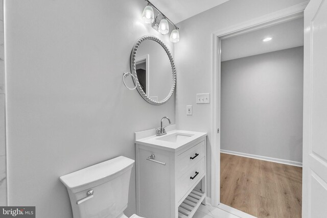 bathroom featuring hardwood / wood-style flooring, vanity, and toilet