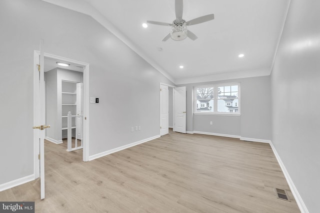 unfurnished room with ceiling fan, lofted ceiling, and light hardwood / wood-style floors