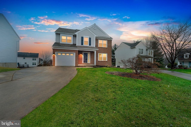 front of property featuring a garage and a lawn