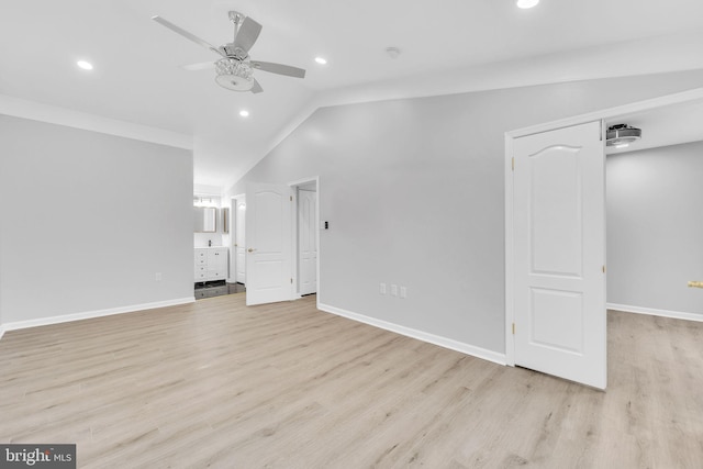 interior space with vaulted ceiling, ceiling fan, and light wood-type flooring