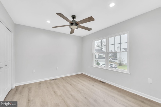 spare room with light hardwood / wood-style floors and ceiling fan