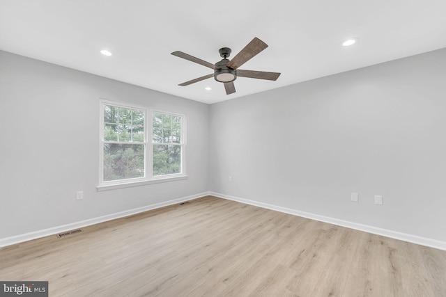 empty room featuring light hardwood / wood-style flooring and ceiling fan