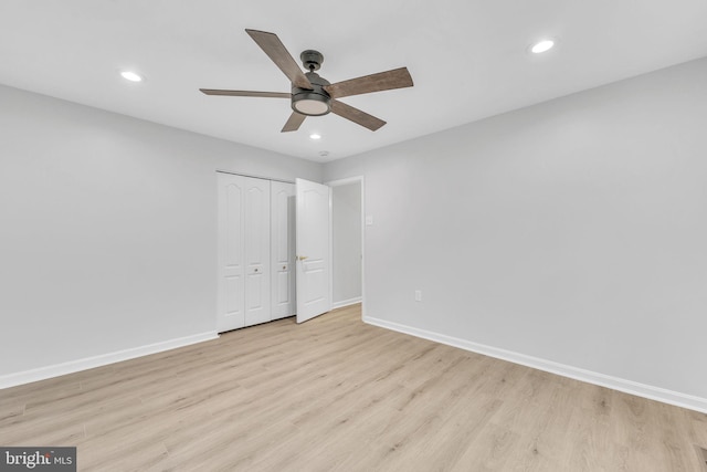 unfurnished bedroom featuring light hardwood / wood-style flooring, a closet, and ceiling fan