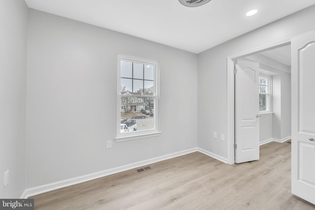 spare room with light wood-type flooring