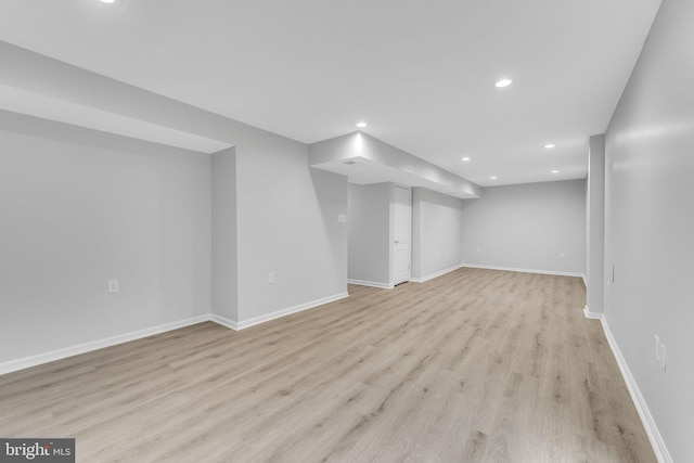 basement with light hardwood / wood-style floors