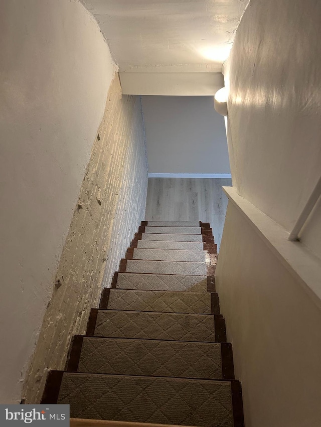 staircase with hardwood / wood-style floors