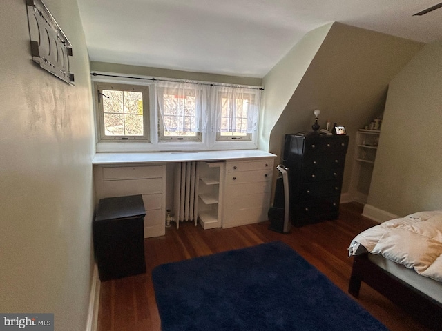 bedroom with dark hardwood / wood-style floors