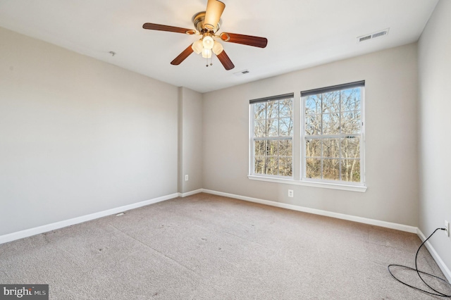 spare room with ceiling fan and carpet floors