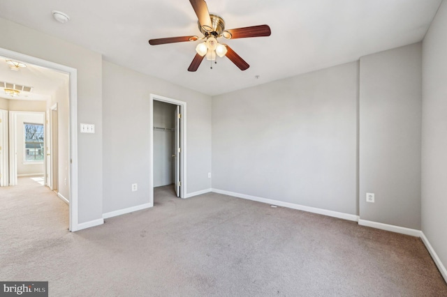 unfurnished bedroom with light carpet, ceiling fan, and a closet