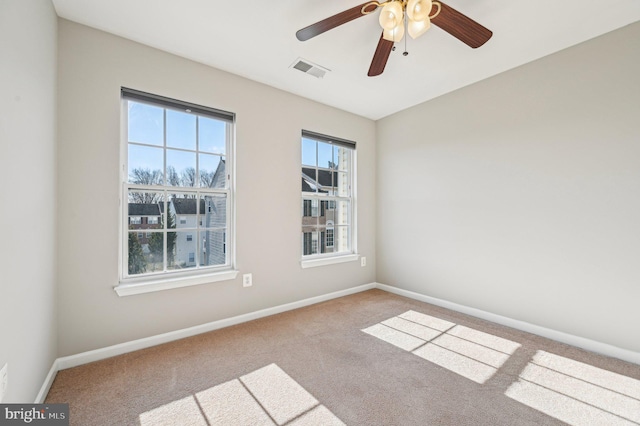 spare room with ceiling fan and light carpet