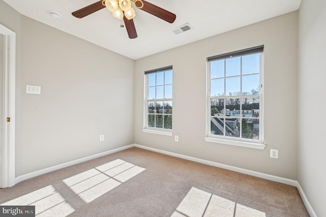 spare room featuring light colored carpet and ceiling fan