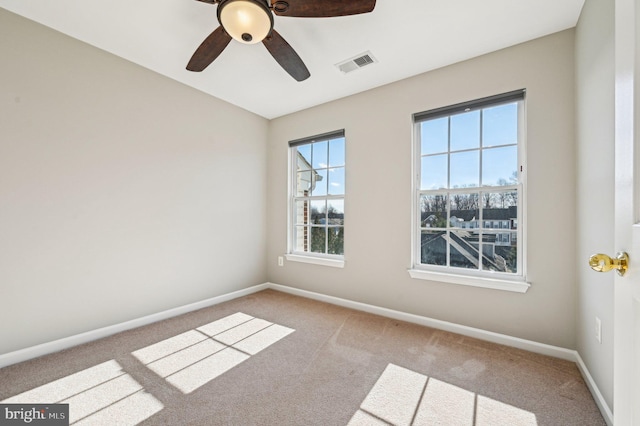 carpeted spare room with ceiling fan