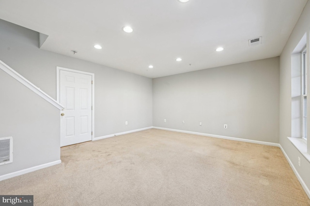 unfurnished room with light carpet