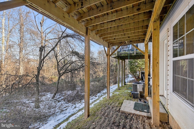 snowy yard featuring central AC