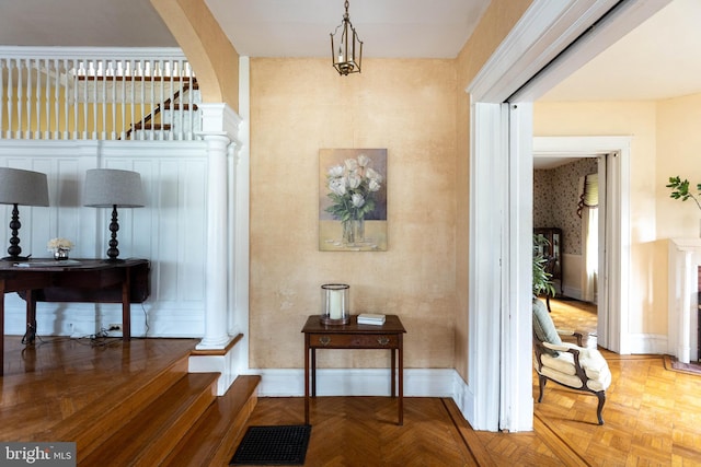 hall featuring visible vents, baseboards, and wallpapered walls