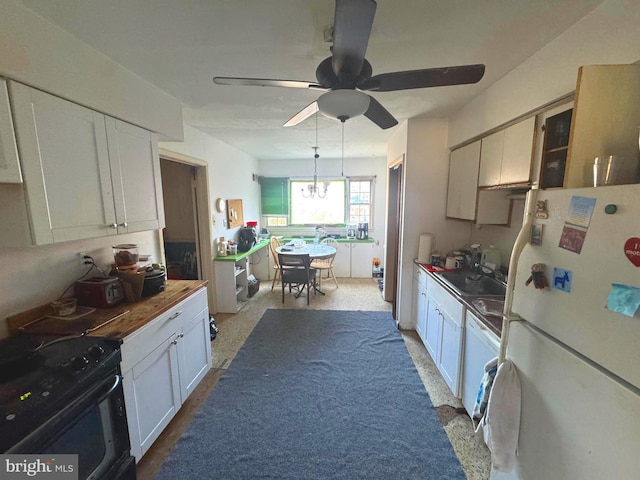 kitchen with butcher block counters, ceiling fan with notable chandelier, white cabinets, and white appliances