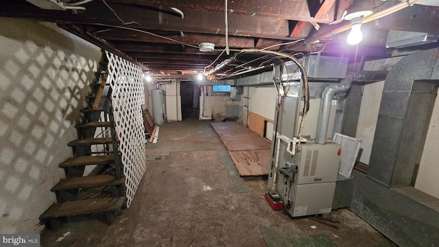 basement with water heater, heating unit, and electric panel