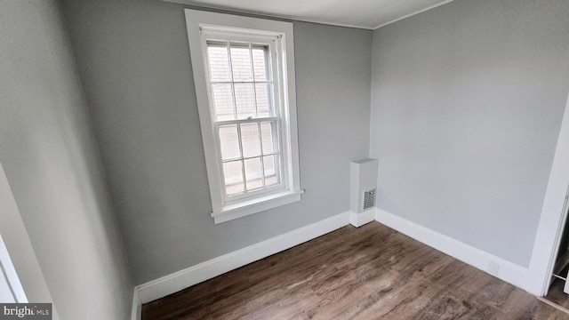 empty room featuring wood-type flooring