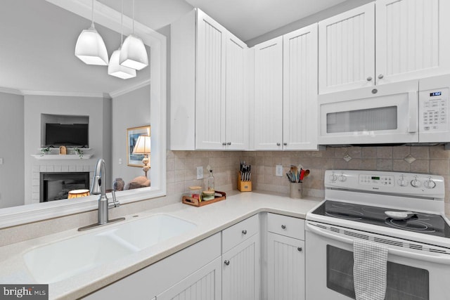 kitchen featuring sink, white appliances, and white cabinets