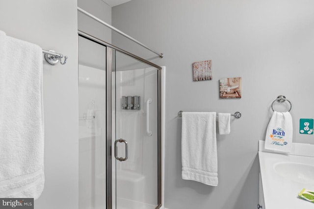 bathroom with vanity and a shower with shower door