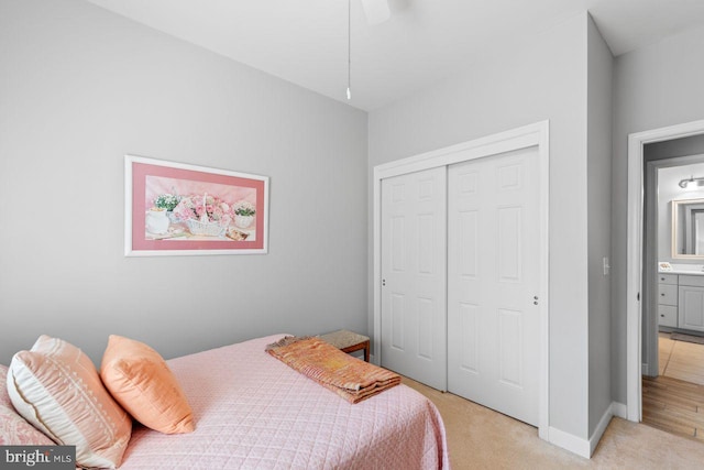 bedroom with a closet and light carpet