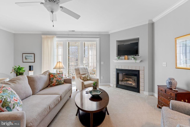 living room with crown molding, light carpet, ceiling fan, and a fireplace