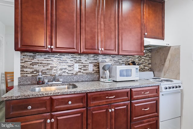 kitchen with sink, backsplash, and white appliances